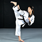 **

"A young woman in a fully clothed Taekwondo uniform, performing a perfect front kick in a bright, clean dojang. Focus on her form and posture. Appropriate attire, safe for work, perfect anatomy, natural proportions, well-formed hands, proper finger count, professional martial arts photography, high quality, family-friendly."

**